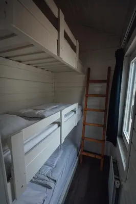 a room with two bunk beds and a ladder at Logeren aan Zee in Katwijk aan Zee