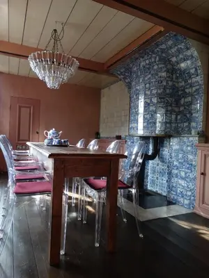 a dining room with a wooden table and chairs at Stay overnight at Windmill Village Zaanse Schans - Amsterdam in Zaandam