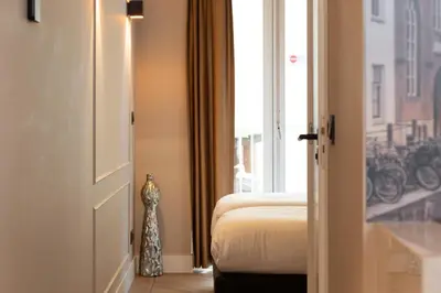 a hotel room with a bed and a window at Midtown Hotel Twin Studio in Amsterdam