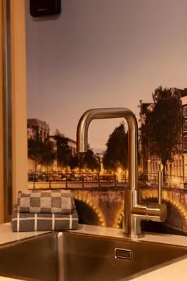 a kitchen sink with a view of a bridge at Midtown Hotel Royal Room in Amsterdam