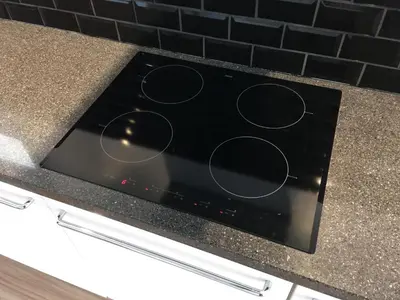 a stove top oven with circles on a counter at Annadora Beach House - Private Parking in Zandvoort
