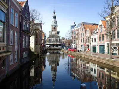 a river with a clock tower in the middle of a city at Holiday Home Bergen near Beach & Dunes in Bergen aan Zee