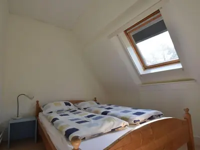 two beds in a room with a window at Holiday Home Bergen near Beach & Dunes in Bergen aan Zee