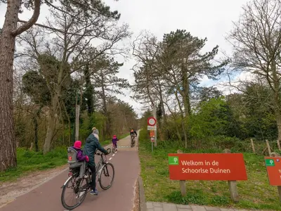 a group of people riding bikes on a bike path at Apartment in Schoorl near Dunes in Schoorl
