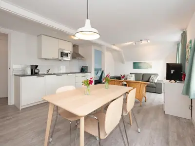 a kitchen and dining room with a table and chairs at Apartment in Schoorl near Dunes in Schoorl