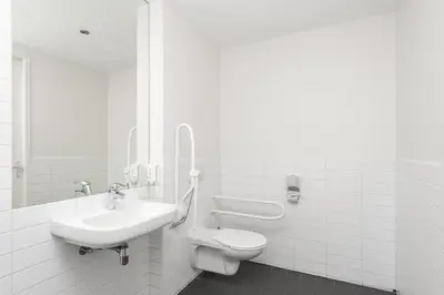 a white bathroom with a sink and a toilet at easyHotel Amsterdam City Centre South in Amsterdam