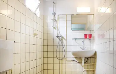a bathroom with a shower and a sink at Huisje Zand En Water in Egmond aan Zee