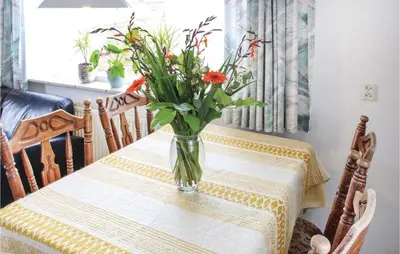 a vase of flowers sitting on a table at Huisje Zand En Water in Egmond aan Zee
