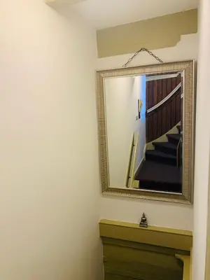 a mirror over a dresser in a room at Amsterdam Central Guest House in Amsterdam