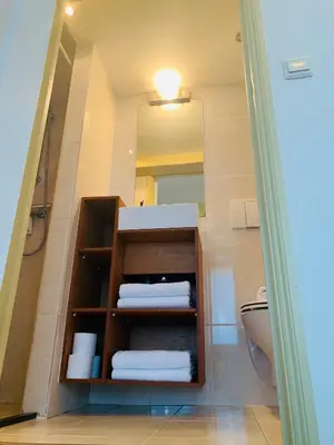 a bathroom with a sink and a toilet and a mirror at Amsterdam Central Guest House in Amsterdam