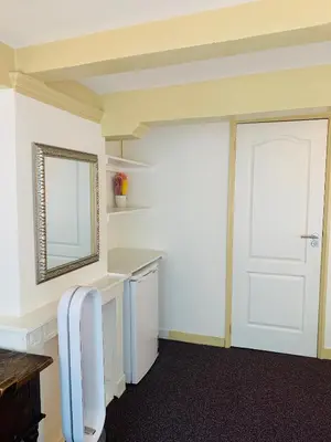 a room with a white door and a mirror at Amsterdam Central Guest House in Amsterdam