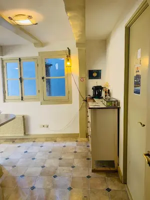 a room with a kitchen with a counter and a window at Amsterdam Central Guest House in Amsterdam