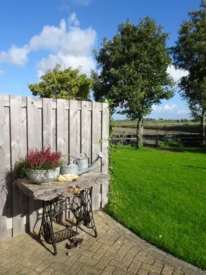 a table with flowers on it next to a fence at Molenzicht in Sint Maarten