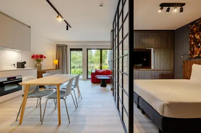 a bedroom with a bed and a table and chairs at Htel Serviced Apartments Amstelveen in Amstelveen