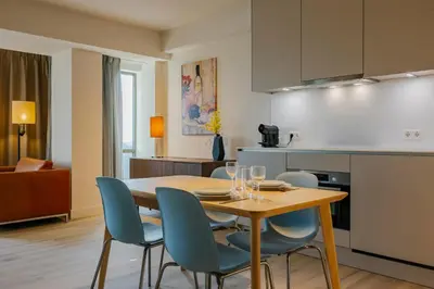 a kitchen and dining room with a table and chairs at Htel Serviced Apartments Amstelveen in Amstelveen