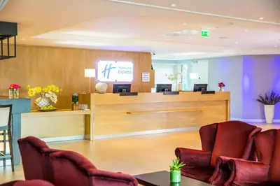 a waiting room with chairs and a cash register at Holiday Inn Express Amsterdam - Sloterdijk Station by IHG in Amsterdam