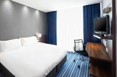 a hotel room with a bed and a tv at Holiday Inn Express Amsterdam - Sloterdijk Station by IHG in Amsterdam