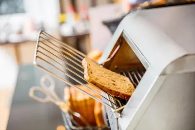 a toaster with a slice of bread in it at Holiday Inn Express Amsterdam - Sloterdijk Station by IHG in Amsterdam