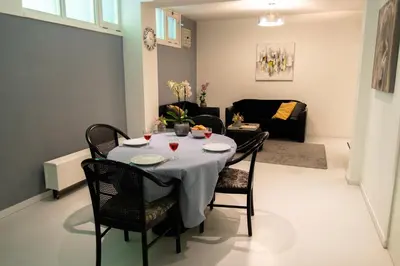 a dining room with a table and chairs in a living room at Excellent 21 in Soesterberg