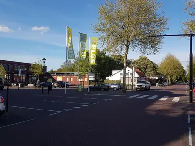 an empty street with cars parked in a parking lot at Excellent 21 in Soesterberg