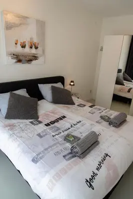 a large bed with avertisementvertisement at Excellent 21 in Soesterberg