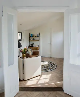 a living room with a couch and a table at Het Torentje aan de IJssel in Montfoort