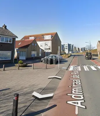 a street with white signs on the side of the road at Duinnachtegaal in Egmond aan Zee