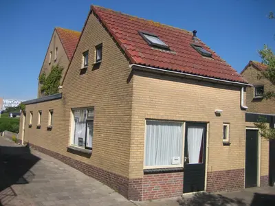 a brick house with a red roof at Duinnachtegaal in Egmond aan Zee