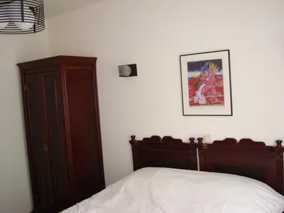 a bedroom with a bed and a wooden cabinet at Hotel Keistad in Amersfoort