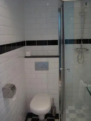a bathroom with a toilet and a shower at Hotel Keistad in Amersfoort