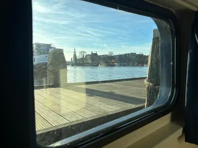 a view of the water from a window of a boat at Hotelboat Iris in Amsterdam