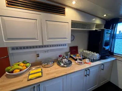 a kitchen counter with a bowl of fruit on it at Hotelboat Iris in Amsterdam