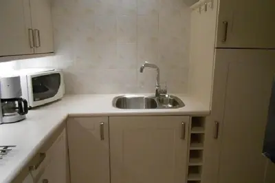 a kitchen counter with a sink and a microwave at Liefting in Egmond aan Zee
