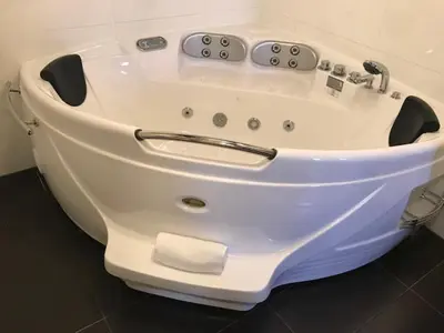 a white bath tub sitting in a room at Alex Rooms in Zwanenburg