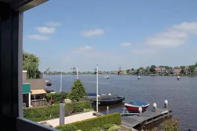 a view of a river with boats in the water at Boutique Hotel Zaan in Zaandijk