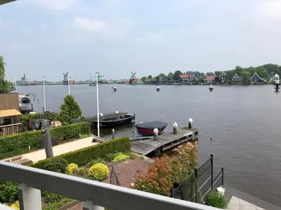 a dock with a boat in a large body of water at Boutique Hotel Zaan in Zaandijk