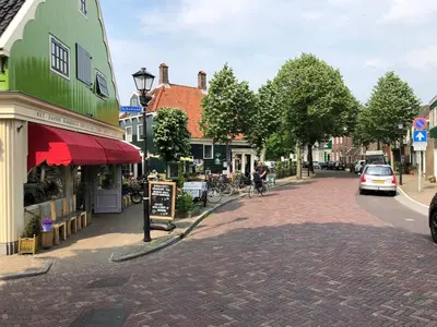 a cobblestone street in a small town with buildings at Boutique Hotel Zaan in Zaandijk
