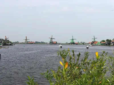 a river with many windmills in the distance at Boutique Hotel Zaan in Zaandijk