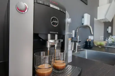 a coffee machine with two cups on a counter at Chill-out in Nieuwe Wetering