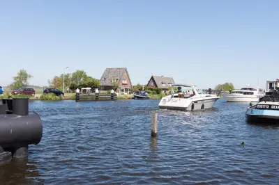 a group of boats docked in a body of water at Chill-out in Nieuwe Wetering