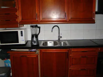 a kitchen with a sink and a blender on a counter at Amsterhouse B&B in Amsterdam