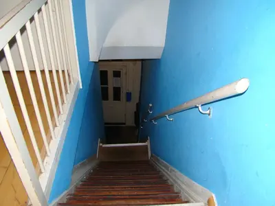 a stairway with a blue wall and a stair railing at Amsterhouse B&B in Amsterdam