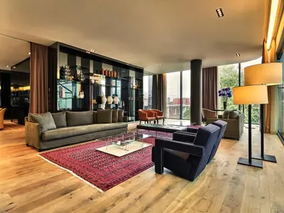 a living room with a couch and a table at Mandarin Oriental Conservatorium, Amsterdam in Amsterdam