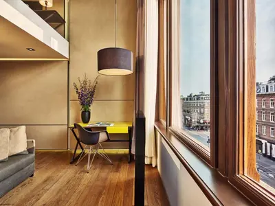 a room with a desk and a window at Mandarin Oriental Conservatorium, Amsterdam in Amsterdam