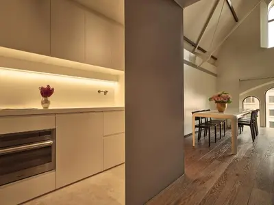 a kitchen with a table and a dining room at Mandarin Oriental Conservatorium, Amsterdam in Amsterdam