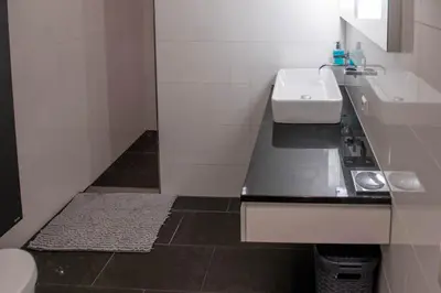 a small white bathroom with a sink and a toilet at Appartement Volendam in Volendam