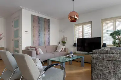 a living room with a couch and a tv at Appartement Volendam in Volendam