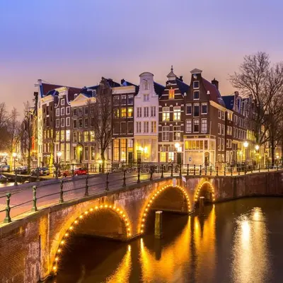 a bridge over a river in a city with buildings at Appartement Volendam in Volendam