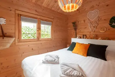 a bedroom with a bed in a wooden room at The Sea Lodge in Zandvoort