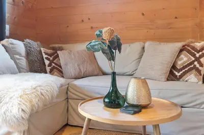 a vase with a flower on a table on a couch at The Sea Lodge in Zandvoort